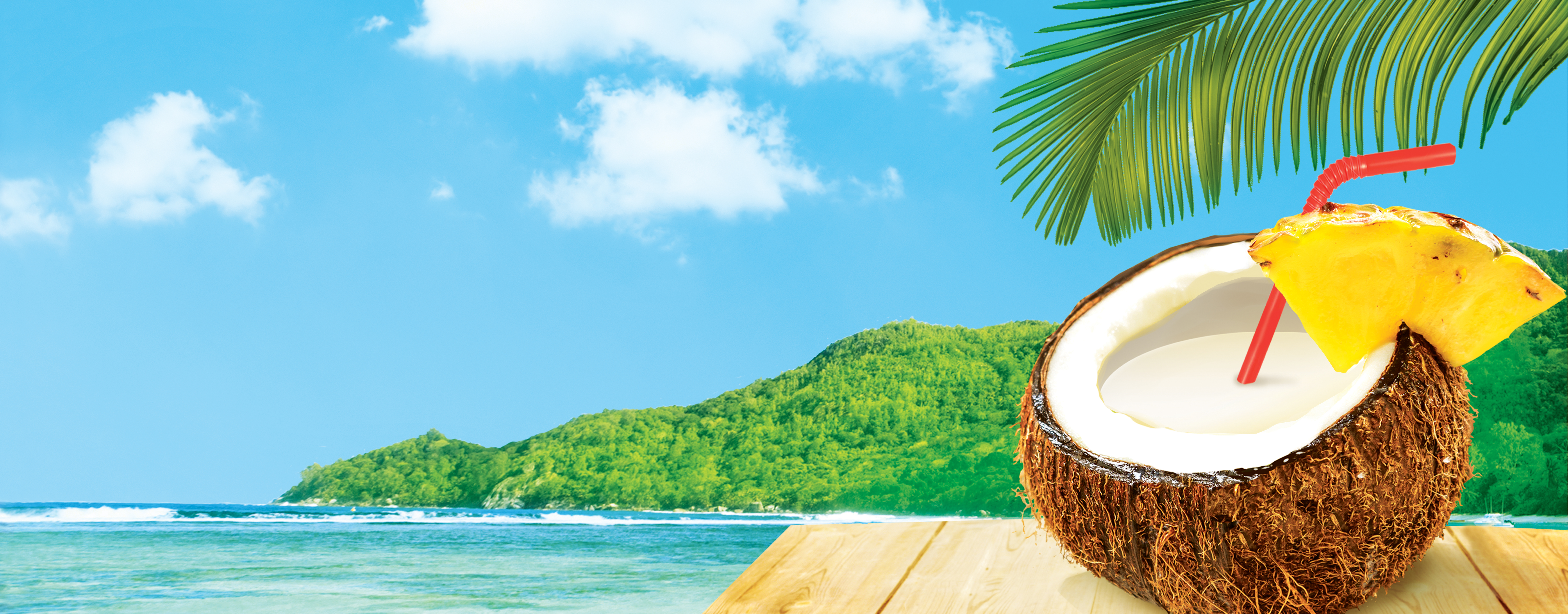 coconut with a straw sitting on table with beach scene behind