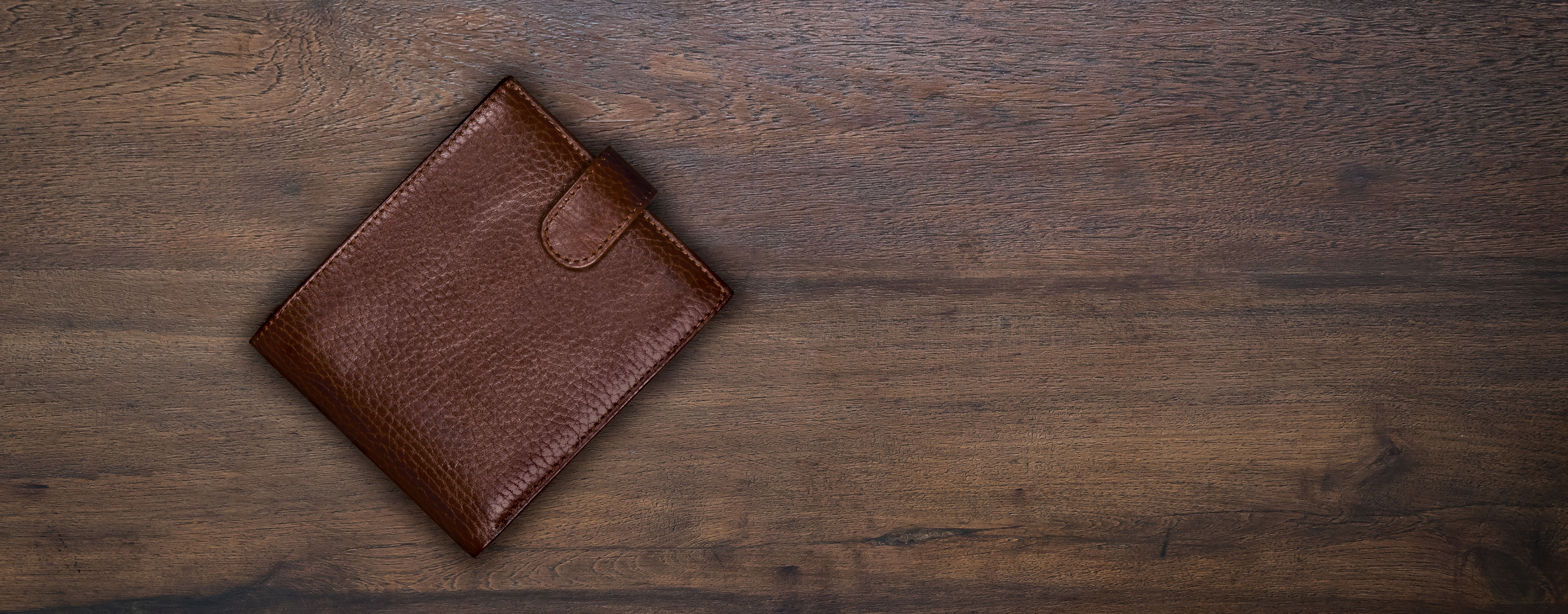 leather wallet on wood surface